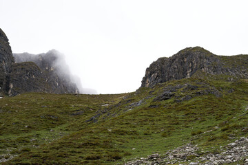Fototapeta na wymiar chamois in far distance on a mountain concealed camouflaged