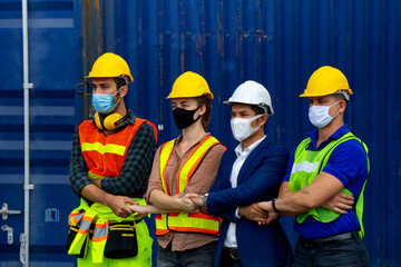 Industrial workers or engineers wearing Coronavirus or COVID-19 protective masks