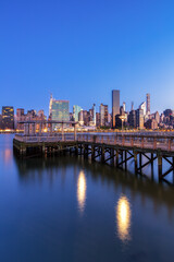Midtown Manhattan view from East River Pier at dawn with long expsoreu