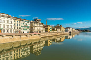 Fototapeta na wymiar FLORENCE, TUSCANY / ITALY - DECEMBER 27 2019: Buildings reflecion in Arno river water in Florence