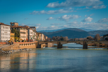 Obraz premium FLORENCE, TUSCANY / ITALY - DECEMBER 27 2019: Buildings reflecion in Arno river water in Florence