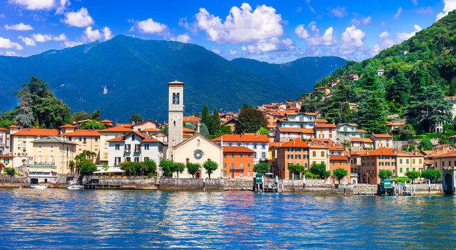 View from lake of Torno idyllic colorful village with mountain background, Lake Como Lombardy  Italy  6k resolution panorama. World print quality, copy space sky and water