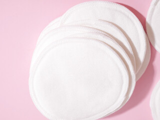 organic cotton pads on pink background. Zero waste, reusable, eco, makeup remover and washing concept. hard light, flat lay, close up