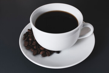 Cup of black coffee with beans