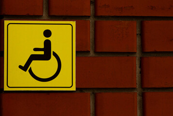 Disabled parking sign on brick wall