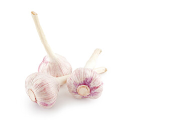 Three fresh heads of young garlic isolated on a white background.