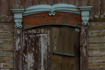 Old wooden window shutters on abandoned house