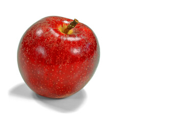 beautiful scarlet red apple, juicy and shiny, isolated on a white background with a drop shadow on the ground