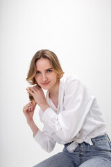 portrait of young smiling caucasian woman with long hair posing in shirt, blue jeans, isolated on white studio background. model tests of pretty girl in basic clothes. attractive female poses, smiles