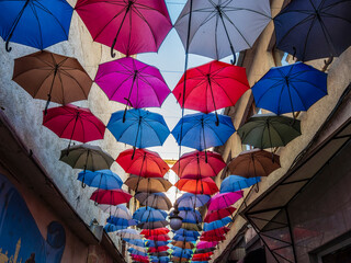 Fototapeta na wymiar Colorful umbrellas on the city streets