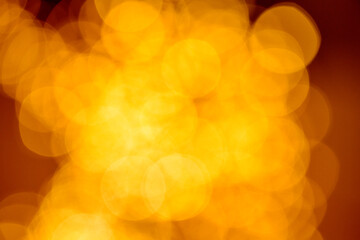 Glitter bokeh baubles. Abstract golden Christmas glowing backdrop on dark background.