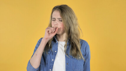 Sick Young Pretty Girl Coughing on Yellow Background