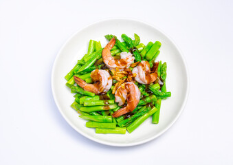 Stirred fried asparagus with shrimp served on white plate isolated on white background. famous thai food in thailand. popular food in Asia.