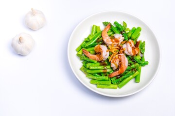 Stirred fried asparagus with shrimp served on white plate isolated on white background. famous thai food in thailand. popular food in Asia.