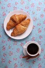 delicious french croissants and a white ceramic coffee cup 