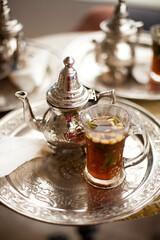 Tunisian traditional green mint tea, served on the silver plate