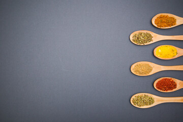 Various kind of spices for food in wooden zero waste spoons. Organic healthy concept 