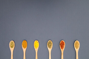Various kind of spices for food in wooden zero waste spoons. Organic healthy concept 