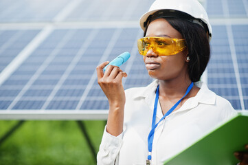 African american technician check the maintenance of the solar panels. Black woman engineer at...