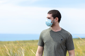 portrait of a man with a face mask in nature