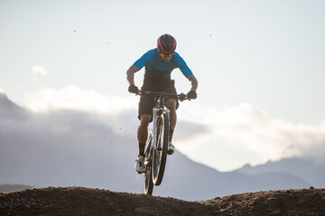 Fototapeta na wymiar Close up image of a mountain biker speeding downhill on a mountain bike track