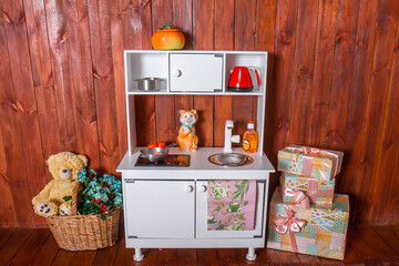 White wooden kitchen for girls play in the nursery