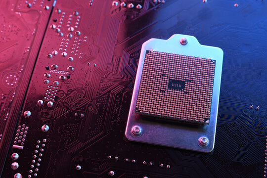 Computer cpu processor chip on circuit board ,motherboard background. Close-up. With red-blue lighting