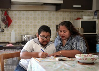 child studies helped by mom at home