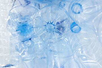 Empty used plastic bottles on a white background. The concept of the problem of environmental pollution by plastic and other nondegradable waste in nature.