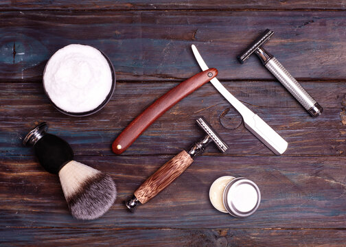 Razors, Brush, And Balsam On A Wood Background.