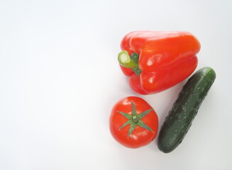 Tomato and sweet red pepper, bell pepper, cucumber, parsley isolated on white background