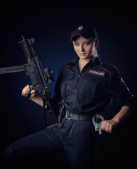 the girl in the police uniform with a gun is a Russian policeman with gun. English translation of 