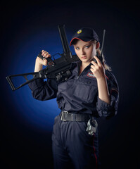 Fototapeta premium the girl in the police uniform with a gun is a Russian policeman with gun. English translation of 