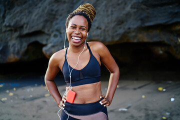 Half length portrait of cheerful sporty woman feeling excited from spending time for morning...