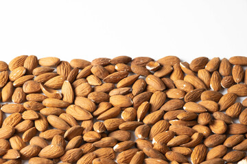 almonds scattered on a table on a white background