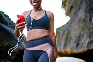Cropped image of afro american female jogger dressed in stylish sport clothes for training...