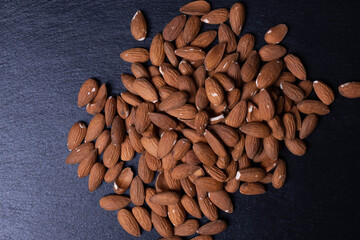 healthy almonds are scattered on a table