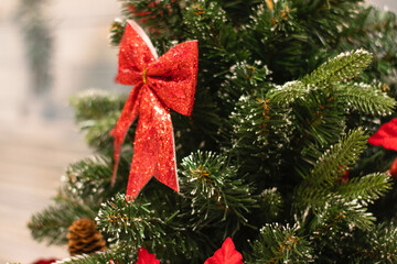 Christmas tree decorated with red bows. New Year mood, Christmas decor, photography.