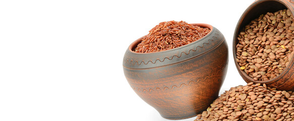 Lentils and brown rice in clay pots isolated on white background. Wide photo. Free space for text.