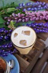 Coffee and tiramisu on the table on the veranda of the coffee shop