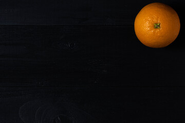 Orange on wooden dark background