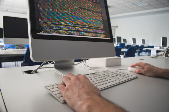 Student programming  with a computer in class