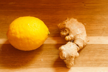 Lemon peel and ginger root. Background wooden desk.