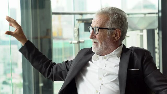 senior businessman talking and consulting to partner Present ideas in restaurant . old man ceo discussing with client in  meeting at cafe . mature manager by window over skyscraper luxury . dating