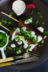 Shish kebab on a stick. Grilled meat skewers on a dark background.