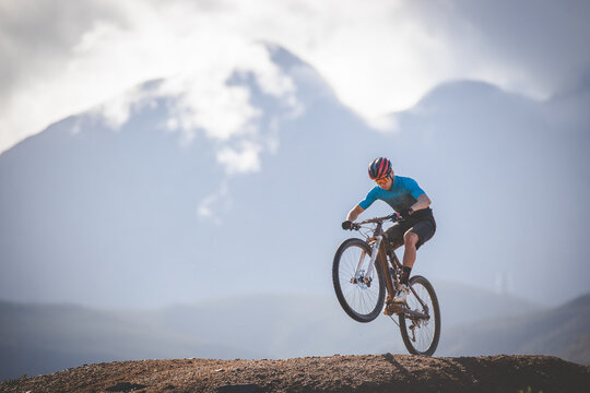 Close up image of a mountain biker speeding downhill on a mountain bike track