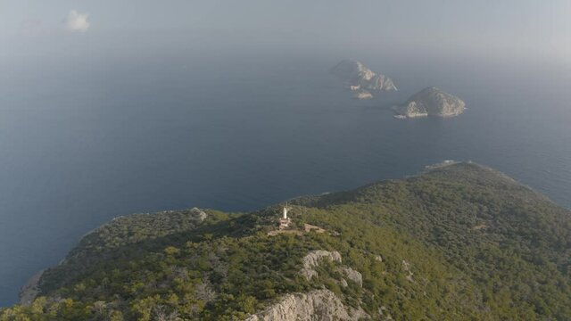 Aerial drone video of lighthouse in the background of greek islands. Natural landscape. Mediterranian sea 