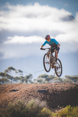 Close up image of a mountain biker speeding downhill on a mountain bike track
