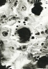 Black ink stains, dots, spatter and splashes on white paper background