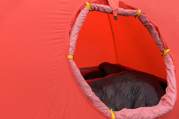 Tourist tent. Open round entrance. Color is red. Concept of temporary housing from fabric of tourists, geologists, travelers.
